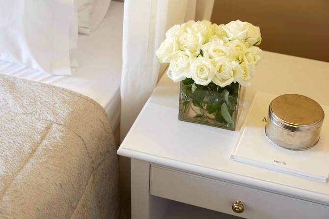 Vase with flowers by the bedside table 1
